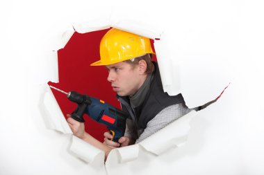 Tradesman demolishing a wall clipart