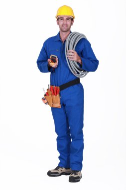 Tradesman holding his tools and corrugated tubing clipart