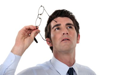 Man taking his glasses off and looking upwards clipart