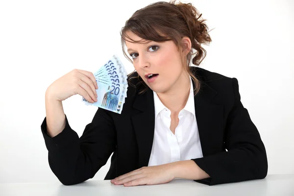 Businesswoman holding bills — Stock Photo, Image