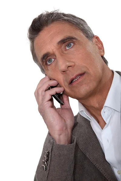Mature man talking on a cellphone — Stock Photo, Image