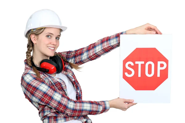 Female construction worker holding stop sign — Stock Photo, Image