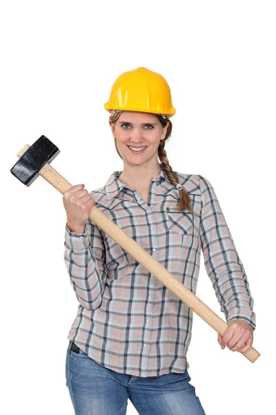 Happy handywoman holding a hammer — Stok fotoğraf