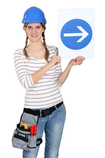 Woman with a one way sign — Stock Photo, Image
