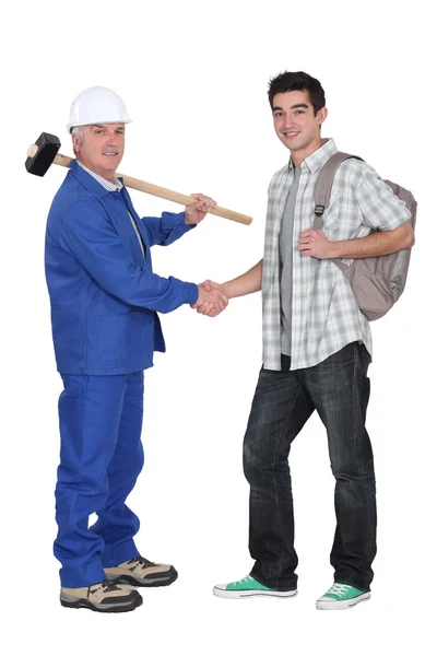 Mature craftsman shaking hands with apprentice — Stock Photo, Image