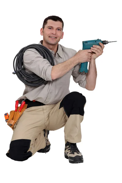 Handyman segurando uma ferramenta elétrica — Fotografia de Stock