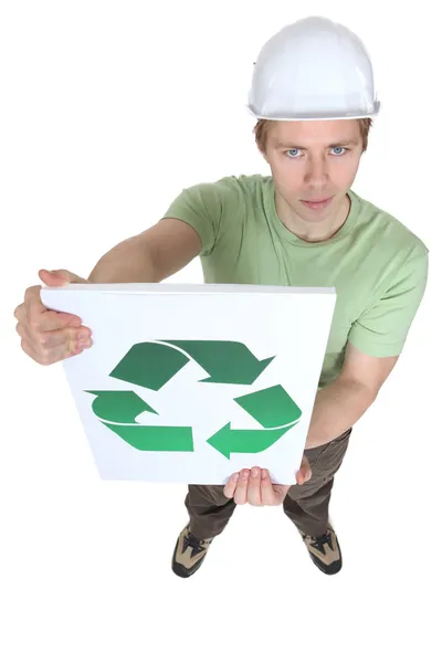 Young man holding sign with symbol of recycling — Stock Photo, Image