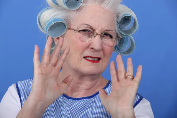 Elder upset with curlers in her hair - Stock Image. 