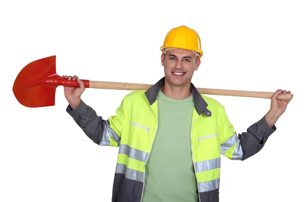 Bir kürek ile bir inşaat işçisi. — Stok fotoğraf