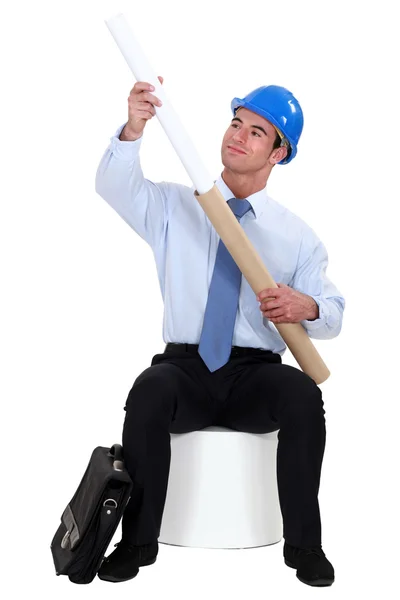 Engineer pulling a rolled-up plan out of its case — Stock Photo, Image