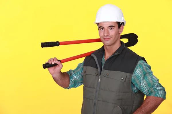 Tradesman carrying a pair of large pliers — Stock Photo, Image