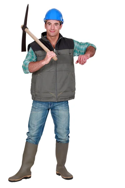 Handsome bricklayer posing with pickaxe — Stock Photo, Image