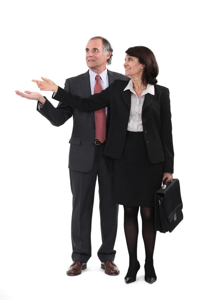 Mature businesscouple gesturing at blank copyspace — Stock Photo, Image