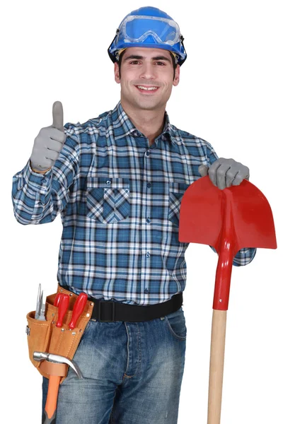 Robotnik z rękawiczki i łopaty, podając kciuki up — Zdjęcie stockowe