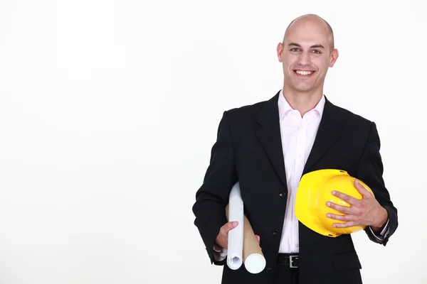 Podnikatel drží helmu a plán — Stock fotografie