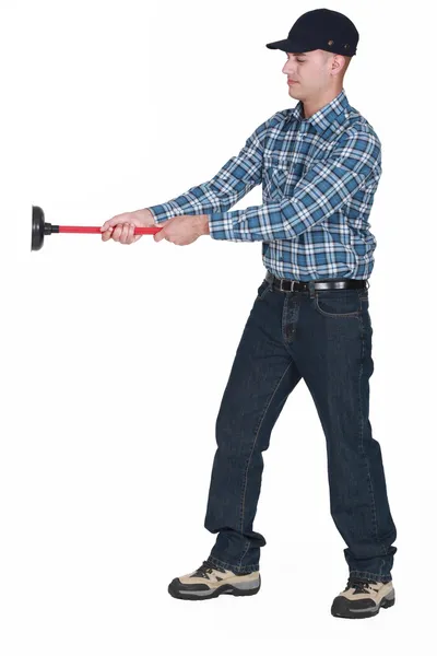 Plumber getting to grips with plunger — Stock Photo, Image
