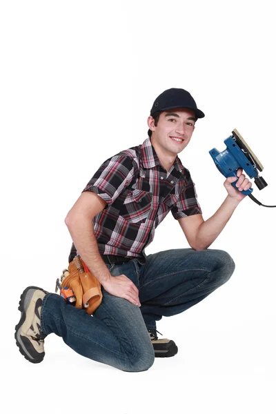 Portrait of young carpenter with sander machine — Stock Photo, Image
