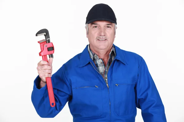 Grey haired man holding wrench — Stock Photo, Image