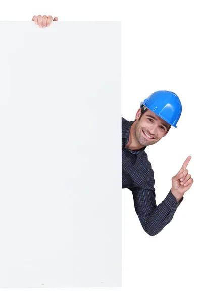 Builder stood by poster — Stock Photo, Image