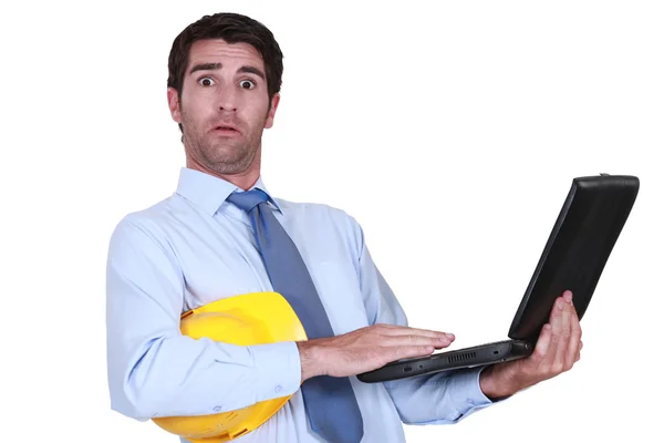 Alarmed engineer with a laptop — Stock Photo, Image