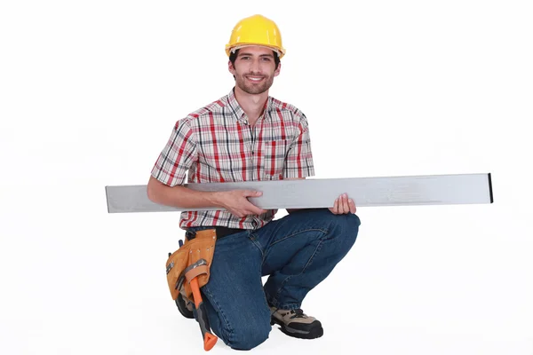 Tradesman carregando uma viga — Fotografia de Stock