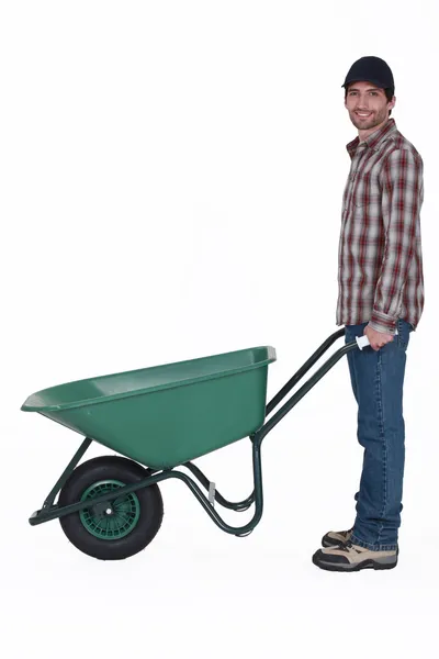 Man with a wheelbarrow — Stock Photo, Image