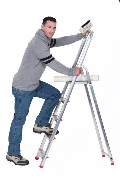 Man putting up wallpaper — Stock Photo, Image