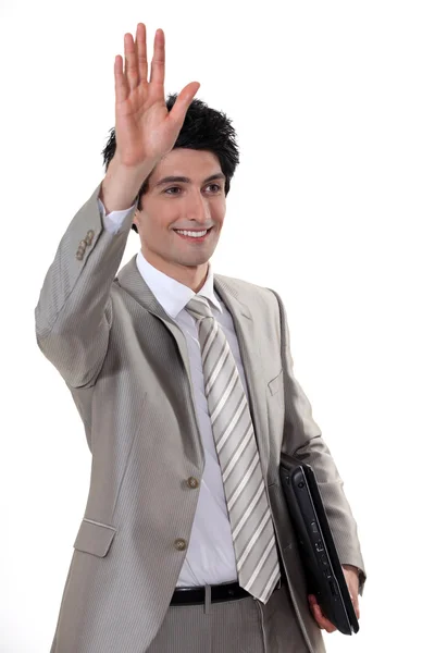 A businessman waving to someone. — Stock Photo, Image