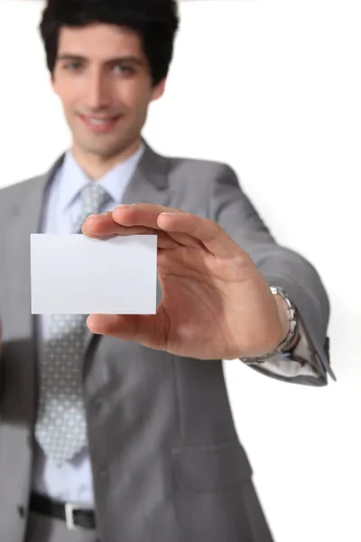 Empresário isolado no fundo branco mostrando cartão de visita — Fotografia de Stock