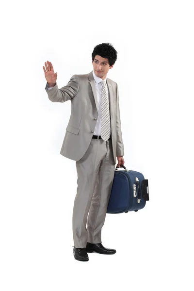Man with suitcase waving goodbye — Stock Photo, Image