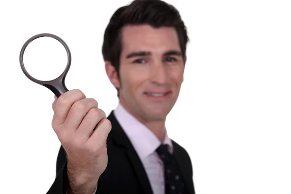 Detective holding magnifying glass isolated on whiet — Stock Photo, Image