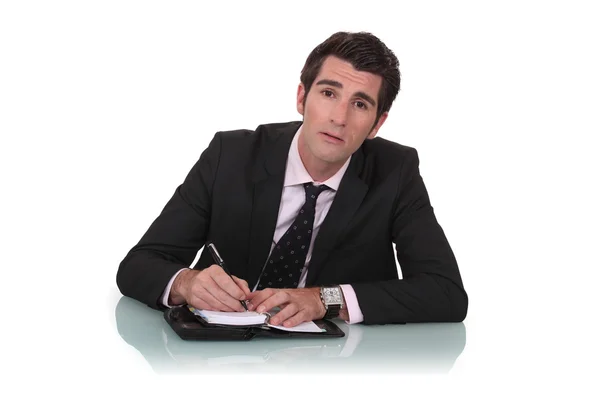 Businessman writing in his diary — Stock Photo, Image