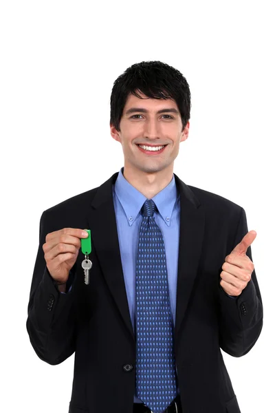 Car salesmen holding keys — Stock Photo, Image