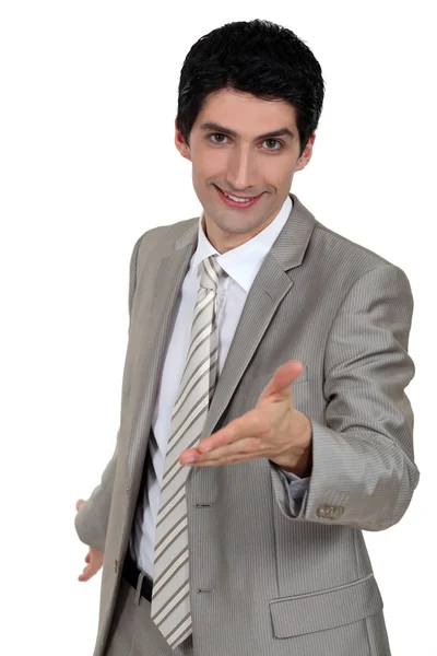 Businessman giving his hand — Stock Photo, Image