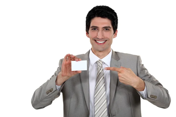 Young businessman pointing at card — Stock Photo, Image