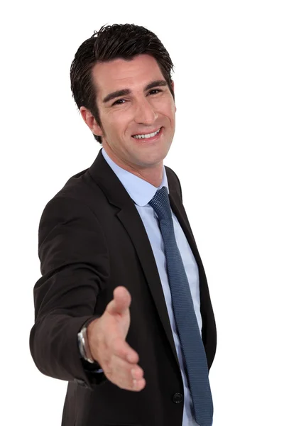 Businessman giving his hand for a handshake — Stock Photo, Image