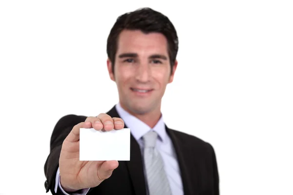 Man holding out his business card — Stok fotoğraf