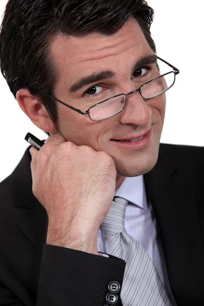 Businessman peering over his glasses — Stock Photo, Image