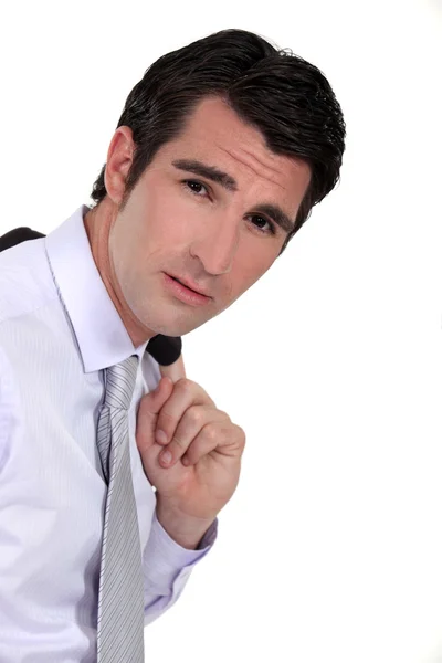 Confident business carrying jacket over shoulder — Stock Photo, Image