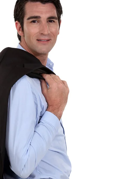 Empresário bem sucedido posando com jaqueta sobre ombro — Fotografia de Stock