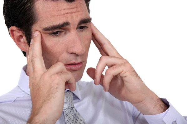 Businessman rubbing his temples — Stock Photo, Image