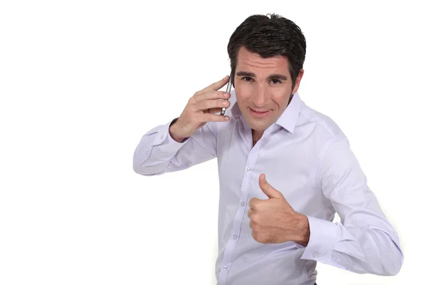 A businessman over the phone giving the thumb up. — Stock Photo, Image