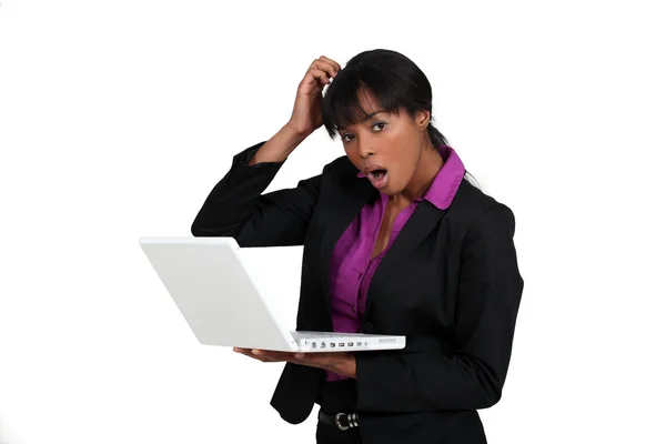 Shocked woman holding laptop — Stock Photo, Image