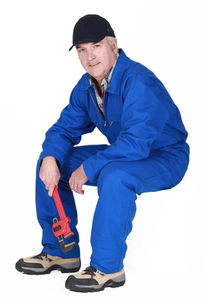 Middle-aged plumber sat down Stock Image