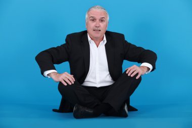 Elderly man sitting on the floor clipart