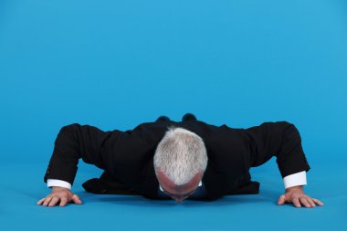 Senior man doing push-ups clipart