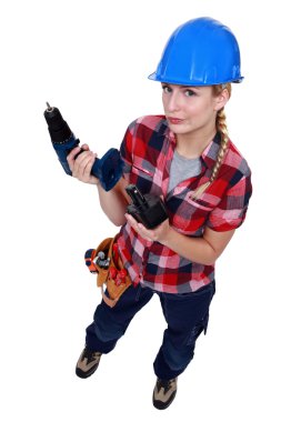 Tradeswoman holding a battery-powered power tool clipart