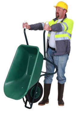 Tradesman emptying a wheelbarrow clipart