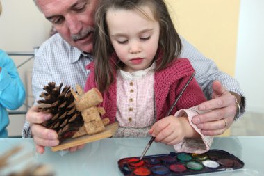 Granddaughter and grandfather painting clipart