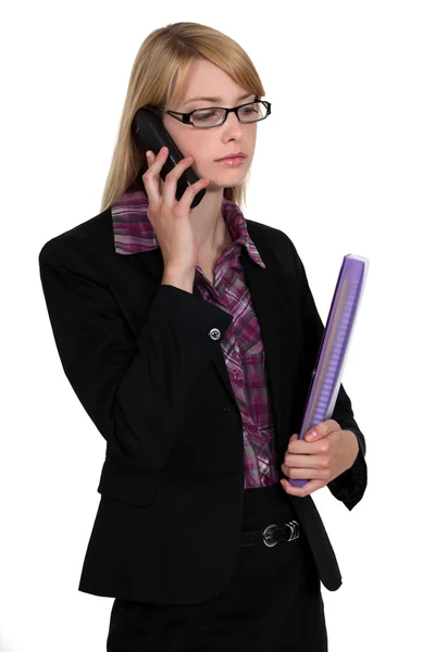 Employee listening to message on her phone — Stock Photo, Image